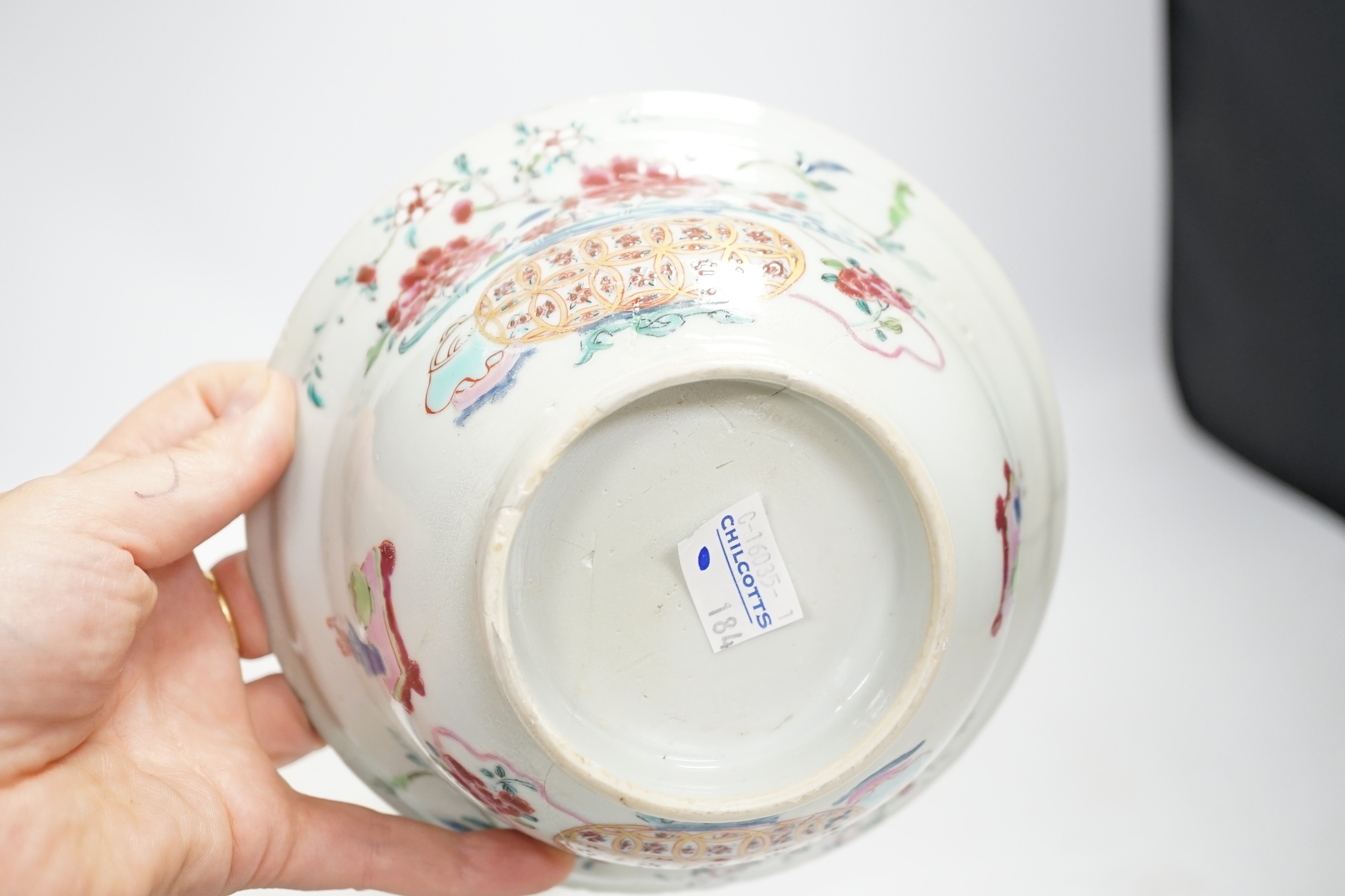 A Chinese famille rose bowl, an Imari patterned bowl, a small blue glazed vase and a similar celadon glazed vase, 18th century and later. Condition - both bowls badly cracked, overall poor